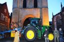 Dean Francis Ward blessing a plough and tractor on the Cathedral Green (near the Norman Tower) in Bury St Edmunds to mark Plough Sunday.