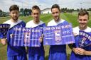 Ipswich Town football players Anthony Wordsworth, Luke Chambers, Cole Skuse and Paul Anderson hold clap-banners that will be given out at Saturdays home game against Millwall.