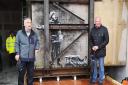 Art dealer John Brandler (left), with garage owner Ian Lewis, with Banksy's Season's Greetings