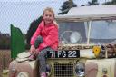 Four-year-old Ruby Reed, with a 1951 Land Rover in desert camouflage, at the Suffolk Aviation Heritage Museum fundraising day in Kesgrave.