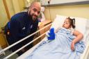 Ipswich Town players brightening up the children's ward at West Suffolk Hospital. David McGoldrick gives Nikita Blenman an Ipswich Town teddy. Picture: GREGG BROWN