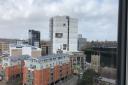 The shrink wrap covering St Francis Tower in Ipswich has come off in Storm Eunice