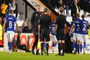 Ipswich Town manager Kieran McKenna speaks with the referee briefly at half time.
