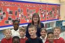 Samantha Porter, Whitehouse's SENDCo, who led on the award process, with some of Whitehouse's pupils and their award
