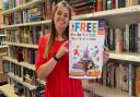 EACH Social Media and Digital Communications Coordinator Lois Livoti with a ‘Free Books for Kids’ poster.