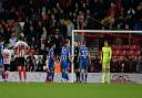 Ipswich players surround the referee after his awarded the home side a penalty at Sunderland