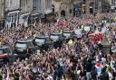 Hundreds of thousands of people are expected to travel to London from Wednesday as the Queen lies in state. Pictured: Crowds watch as the hearse carrying the coffin of Queen Elizabeth II passes Mercat Cross in Edinburgh.