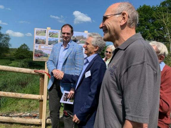 Ipswich Star: Dr John Warren (centre) at the unveiling of a restored footbridge at Baylham on the river Gipping Ipswich Star: Dr John Warren (centre) at the unveiling of a restored footbridge at Baylham on the river Gipping
