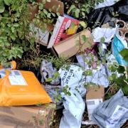 At least 25 parcels were found dumped in a bush close to a public footpath
