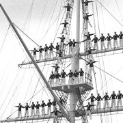 The mast manning ceremony at HMS Ganges with the button boy standing on top. Picture: DAVE KINDRED