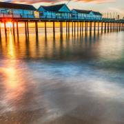 Sunburst through Southwold Pier, one of the tourist attractions in East Suffolk