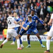 Bersant Celina is eased off the ball by Josh McEachran  at MK Dons.