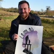Joe Barnes with his design for the Festival of Suffolk symbol