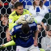 Ipswich keeper Vaclav Hladky climbing over teammate George Edmundson as he makes a second half save