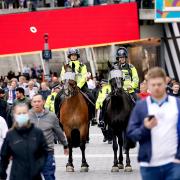 Mounted police patrol outside of Wembley Stadium as fans arrive ahead of the UEFA Euro 2020 Group D match between England and Scotland. Picture date: Friday June 18, 2021.