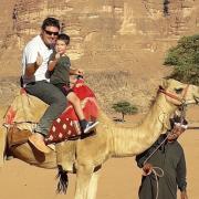 Justin and Oscar on a camel ride in Jordan