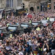 Hundreds of thousands of people are expected to travel to London from Wednesday as the Queen lies in state. Pictured: Crowds watch as the hearse carrying the coffin of Queen Elizabeth II passes Mercat Cross in Edinburgh.