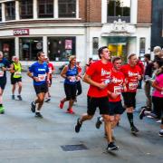 10k runners pass the Giles statue during the Twilight Run. Picture: STEVE WALLER