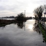 Bridge Road in Snape. Flood water from the tidal surge has started to recede.