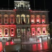 Ipswich Town Hall being lit up red for Remembrance