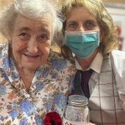 Evelyn Steward with Liz Cotton and the knitted poppies they both had a hand in creating