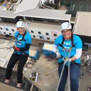 Claire Moore (left) and Hayley Reed abseil down Ipswich Hospital