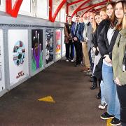 Suffolk New College students with the artwork at Ipswich station.
