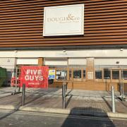 Five Guys banners have been seen on railings outside the former Dough & Co in Ipswich
