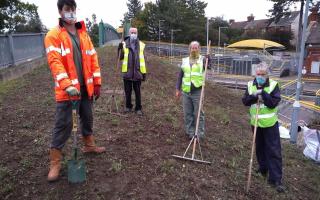David Dowding, wildlife ranger for Ipswich Borough Council’s wildlife ranger team, and Derby Road station adopter's Dennis Carpenter, Claire Kendal and Tom prepare the pollinator patch