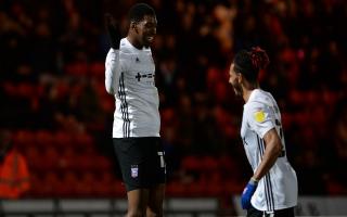 Tyreeq Bakinson (left) celebrates opening the scoring for Ipswich at Doncaster along with Dominic Thompson.