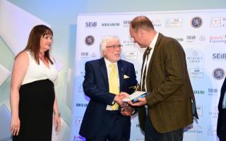 Trevor Hunnaball has won a lifetime achievement award after spending 65 years in the funeral industry